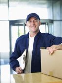 Courier with clipboard and cardboard box